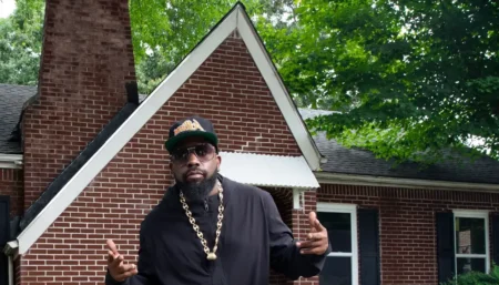 A modern, stylish exterior view of Andre 3000 House showcasing elegant architecture, lush landscaping, and a glimpse of the artist's unique taste in home design.