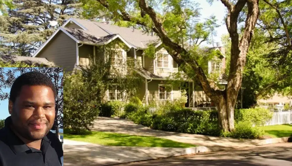 Aerial view of the luxurious Anthony Anderson House in Encino, showcasing the landscaped backyard, pool, and modern outdoor living space.